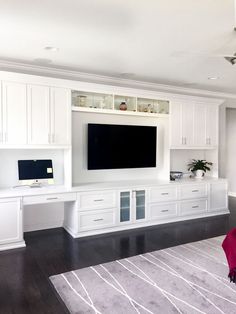 a living room filled with furniture and a flat screen tv on top of a wall