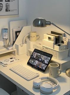 a laptop computer sitting on top of a white desk