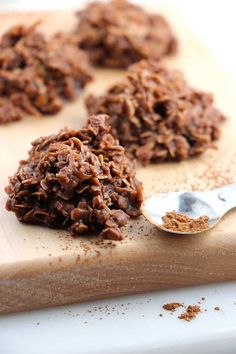 chocolate cookies are on a cutting board with a spoon