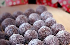 chocolate covered donuts sitting on top of a wooden table