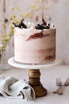 a close up of a cake on a plate with flowers in the background and napkins