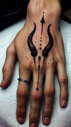 a person's hand with a tattoo on it and an arrow in the middle