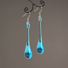 "These Light blue long teardrop dangle earrings are made of glass in lampwork technique. The stainless steel hooks are hypoallergenic. They will not tarnish, fade, or discolor with time. These unique and beautiful earrings are like water drops frozen in glass! They are simple and elegant, very lightweight and comfortable to wear, perfect for everyday wear and for special occasions. You will definitely receive lots of compliments on your new earrings, everybody loves them, and you'll love them to Blue Long Drop Teardrop Earrings With Ear Wire, Modern Blue Long Drop Earrings, Modern Blue Long Drop Jewelry, Blue Nickel-free Long Drop Teardrop Earrings, Blue Long Drop Teardrop Earrings Gift, Blue Teardrop Drop Earrings, Blue Nickel-free Teardrop Earrings, Blue Teardrop Earrings With Ear Wire, Nickel Free Blue Teardrop Earrings