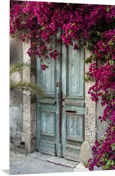 an old door with flowers growing over it