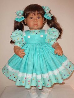 the doll is wearing a blue dress with polka dots on it's sleeves and feet