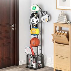 a black rack with basketballs, balls and other sports items on it next to a door