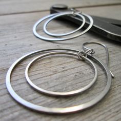 I have been having fun with stainless steel earrings lately and here is another pair. These are larger than the other pair listed (shown in the last few photos). These are 2" in total length and have a titanium ear wire. These are completely hypoallergenic earrings. The circle shaped connectors are perfect for a minimalist look. These will not tarnish or change over time. The largest circle link is 35mm in size, the small one is 25mm. These are smooth and exactly the same front and back. The jump rings are also stainless steel.  You have a choice on how these hang. Look at the 6th photo to see your choice.  To find all the stainless steel options in my shop start here, https://www.etsy.com/shop/CraftLikeAnArtist?search_query=stainless+steel Lake Forest, Steel Earrings, Hypoallergenic Earrings, Circle Shape, Gift For Friend, Stainless Steel Earrings, Circle Earrings, Having Fun, Ear Wire