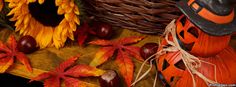 an arrangement of autumn leaves, pumpkins and other decorations on a wooden table with a black hat