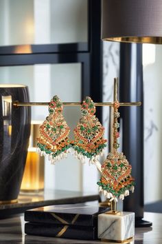 Elevate your festive attire to dreamy perfection with the Sarah - Chandelier Earrings & Maang Tikka Set, an embodiment of grandeur and allure. This exquisite earrings & maang tikka set is meticulously embellished with the splendor of multi-color stones and embellishments, adding a touch of magic to your look. The set includes a pair of stunning chandelier earrings and a maang tikka, each designed to captivate. With an approximate earring length of 3.5 inches, they are a symbol of elegance and op Temple Jewelry Bridal Earrings For Eid Celebration, Festive Fusion Chandelier Earrings With Latkans, Festive Fusion Style Dangle Danglers, Festive Fusion Dangle Danglers, Festive Fusion Bridal Earrings With Hand Set, Bridal Tilla Earrings For Festive Celebrations, Kundan Fusion Bridal Earrings For Celebrations, Fusion Bridal Earrings For Diwali Celebration, Fusion Style Bridal Earrings For Diwali Celebration