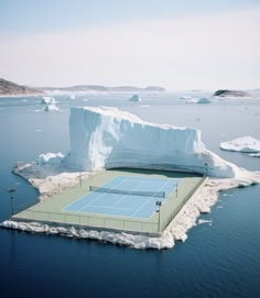 an iceberg floating in the ocean with a tennis court on it's side