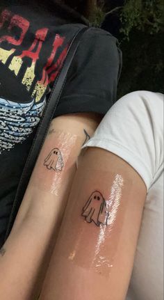 two people with matching tattoos on their arms