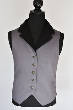 -Mens Steampunk Vest -  Please check sizing measurements before purchasing. This is a fitted vest so please make sure your ordering the right size for your measurements. :)  FEATURES: This elegant steampunk inspired vest has been 100% handmade from all cotton fabrics.  The vest incorporates a brass metal buttons and waist belt at back. The vest is made to a high quality and is fully lined.  All fabrics, threads and accessories are of high quality. This is a 100% handmade and sustainable garment. Punk Style Fitted Vest For Cosplay, Fitted Black Vest With Buttons, Fitted Gothic Vest For Halloween, Fitted Gothic Vest For Cosplay, Gothic Vest For Halloween Cosplay, Fitted Vest For Larp And Halloween, Steampunk Fitted Vest With Buttons, Steampunk Vest For Halloween Cosplay, Gothic Fitted Vest With Buttons