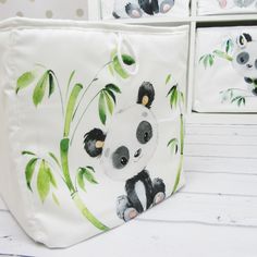 three panda bears painted on white bags with green leaves and polka dot wallpaper behind them