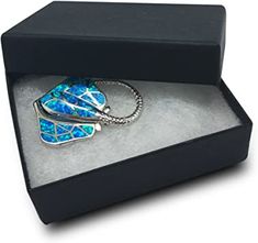 a black box with a blue and white necklace in it