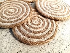 four woven coasters sitting on top of a table