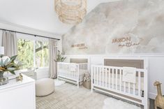 a baby's room with two cribs in it