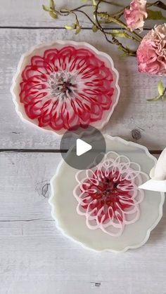 the video shows how to cut paper flowers with scissors and cutters on a white wooden surface