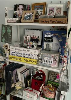 a shelf filled with lots of books and pictures