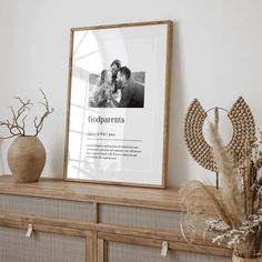 a framed photograph sitting on top of a wooden shelf