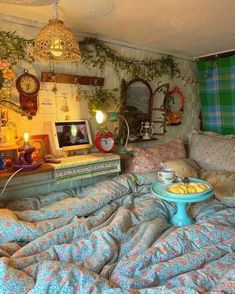 a bed room filled with lots of pillows and blankets