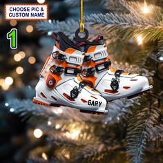 an ornament hanging from a christmas tree with skis and snowboards on it