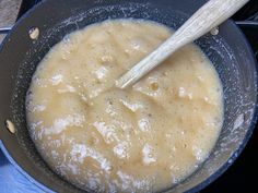 a pan filled with food and a wooden spoon