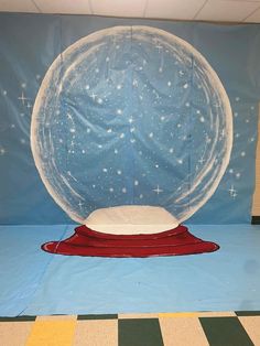 a large snow globe sitting on top of a blue floor