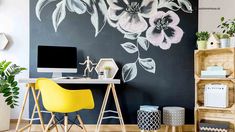 a black and white floral wall mural in an office with yellow chair, computer desk and bookshelf