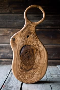 a wooden vase sitting on top of a wooden floor