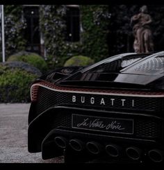 a black sports car parked in front of a building