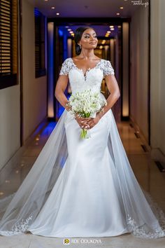 a woman in a white wedding dress and veil