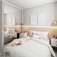 a bedroom with white and pink decor on the walls, two mirrors above the bed