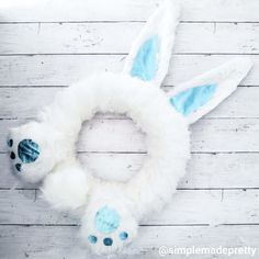 a white wreath with blue eyes and ears