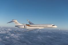 an airplane is flying high above the clouds