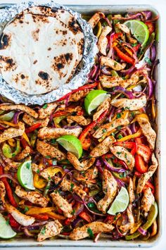 chicken fajita with peppers and onions in a pan