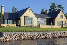 a large house sitting next to a body of water