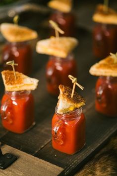 small jars filled with food sitting on top of a wooden table