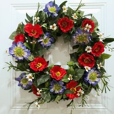 a wreath with red, white and blue flowers