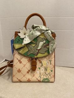 a handbag with an image of a frog on it