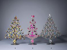 three different types of christmas trees with colored stones on them, all in various shapes and sizes