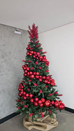 a christmas tree with red balls and greenery