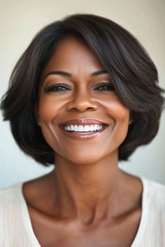 Short Bob with Face-Framing Layers Hairstyle on a smiling black woman in her 50s with short dark brown hair.