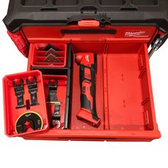 an open tool box with tools in it that include drill, screwdrives and other items