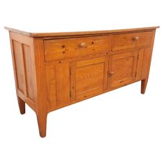 an old wooden sideboard with drawers and knobs