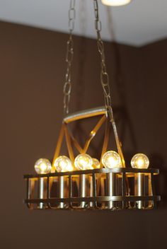 a chandelier with several lights hanging from it's sides in a room