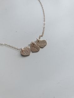 Gold Heart necklace stamped with an anniversary or birthday or initial Personalized Delicate Rose Gold Heart Necklace, Dainty Hand Stamped Heart Necklaces, Dainty Heart-shaped Hand Stamped Charm Necklace, Simple Personalized Heart-shaped Necklace, Valentine's Day Double Heart Hand Stamped Necklaces, Dainty Hand Stamped Heart Charm Necklace, Dainty Hand Stamped Heart Jewelry, Minimalist Nickel-free Necklace For Valentine's Day, Minimalist Hand-stamped Necklaces For Valentine's Day