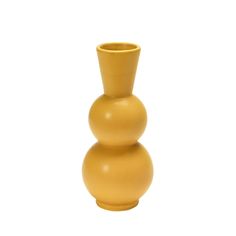 a yellow vase sitting on top of a white table