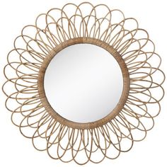 a round mirror that is made out of rattan and has an intricate design on it