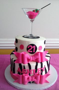 a decorated cake with a martini glass on top