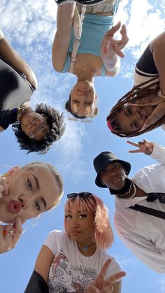 a group of people standing in a circle with their hands up to the camera and pointing at them